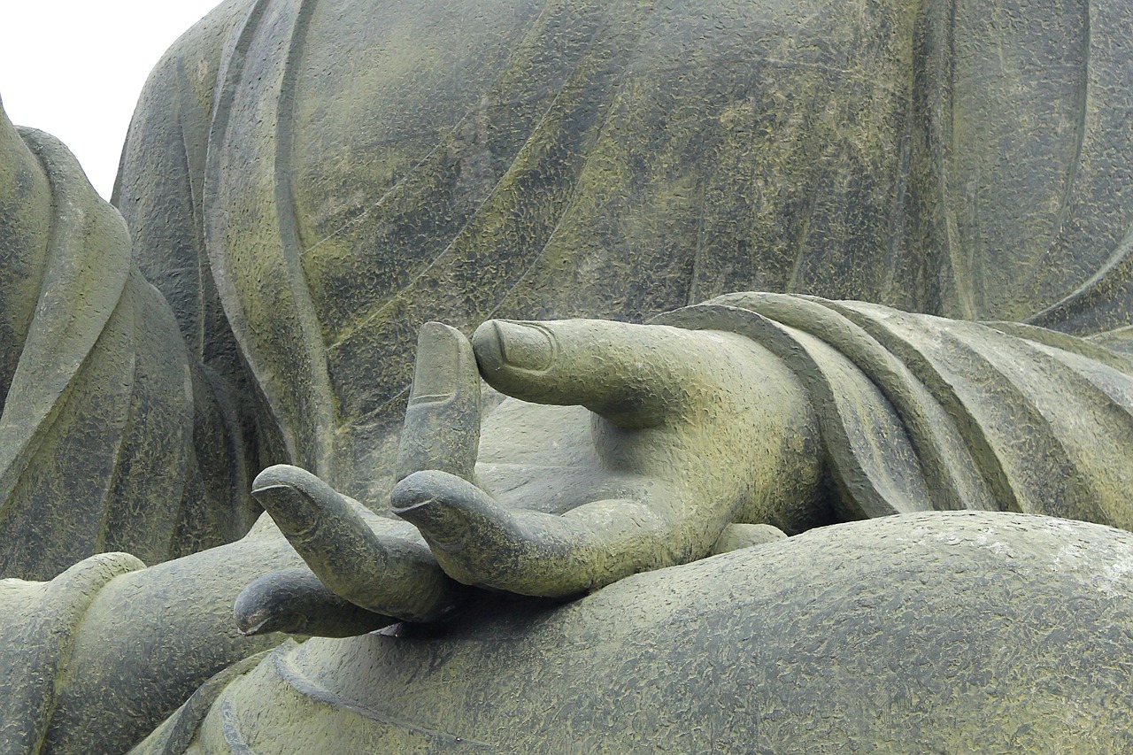 Closeup of Buddha Statue holding hand in prayer